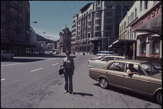 A woman standing in the road next to the Midland Hotel