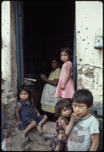 A woman and children standing in a doorway