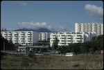 A number of building with mountains in the distance