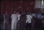A group of men standing on a dance floor