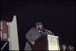 Fidel Castro at a podium on a stage