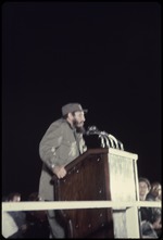 Fidel Castro at a podium on a stage