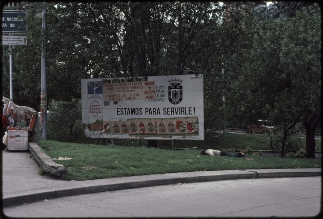 Street scene with a billboard covered in flyers