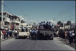 Police marching in the street and in trucks during 1990 Haitian general election