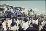 Police in a truck driving through a crowd of people during  the 1990 Haitian general election