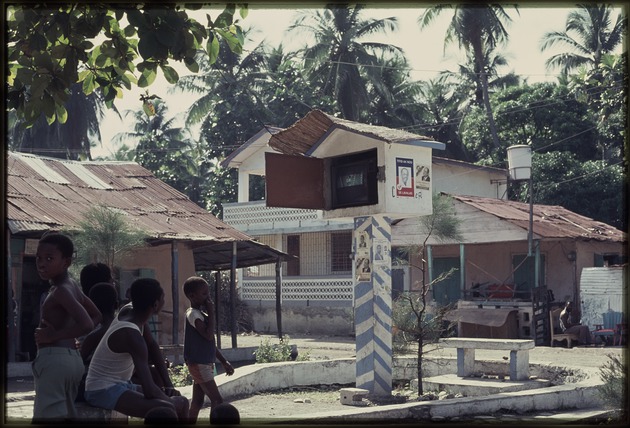 A group of children watching television outside