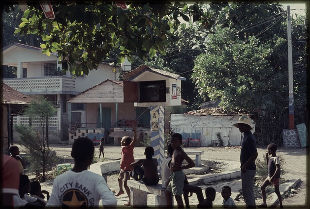 A group of children watching television outside