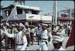 Three uniformed men marching on on Rue J J Dessalines