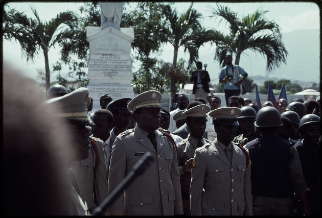Prosper Avril and a group of Haitian military officers standing in front of a statue