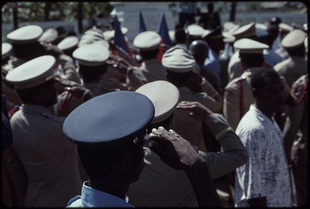 Prosper Avril and a group of Haitian military officers standing in front of a statue