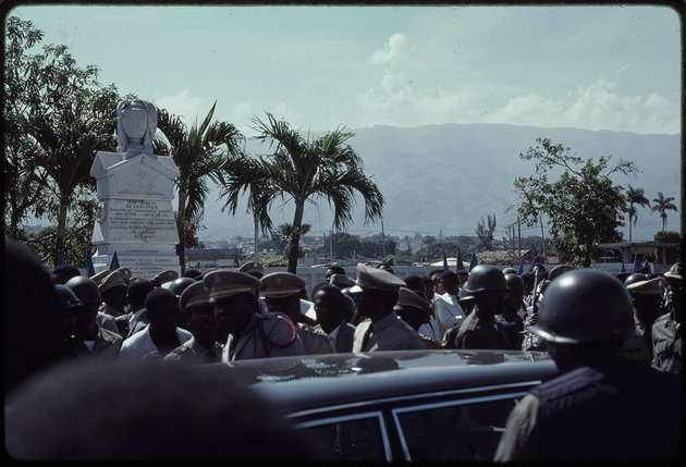 A group of Haitian military officers standing in front of the Jean Jacques Dessalines monument