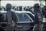 A car with a Haitian military escort at the Jean Jacques Dessalines monument
