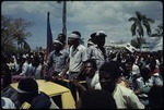 People on a truck with Haitian flag uring the 1990 Haitian general election