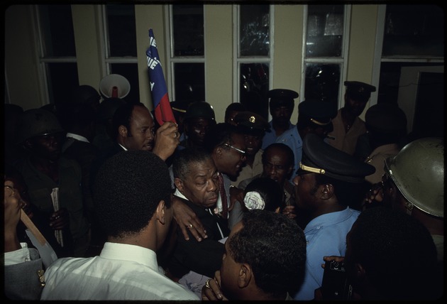 A group of men with Haitian police escort