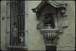 Cirilo Villaverde bust next to a house window