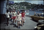 A group of men walking seaside, Grenada