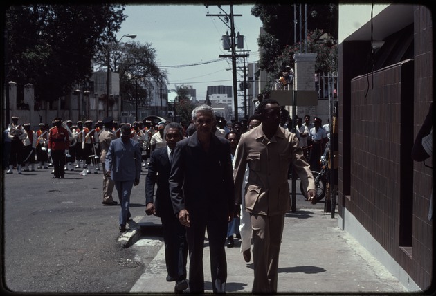 Michael Manley walking on the sidewalk in Kingston, Jamaica