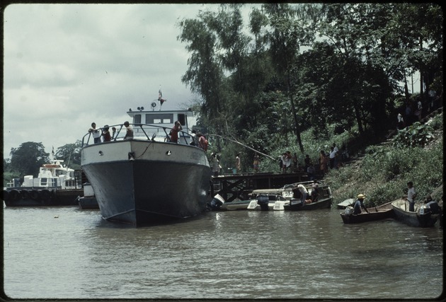 Workers and ships at a dock