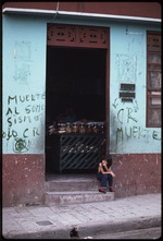 One child sitting in the doorway of the store, Antonio Palma Davila agente de placas
