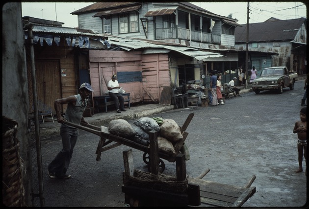 Street scene man pushing a wheelbarrow