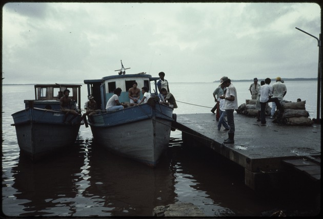 Two boats next to a dock