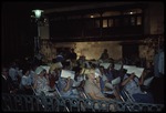 A group of people sitting in the Museo de Ambiente Historico Cubano