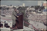 Fidel Castro standing at a podium during the 10th anniversary of the Cuban revolution