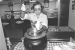 A student serving soup in the cafeteria, University House, Florida International University