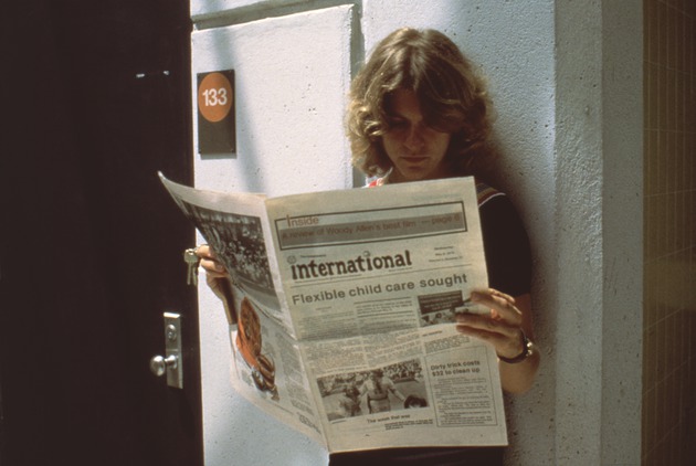 Student reading the student newspaper
