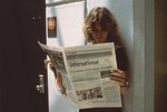 Student reading the student newspaper
