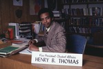 [1981-02] Henry B. Thomas, Vice President Student Affairs seated at office desk