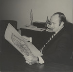 Charles Perry reading a map of Florida International University