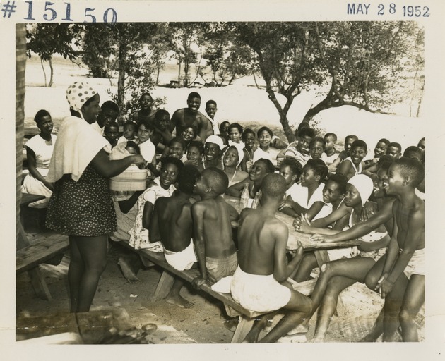 Children sitting on picnic benches