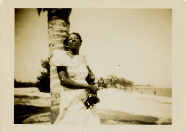 Woman leaning against palm - Recto