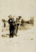 Two men carrying calf