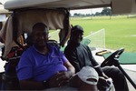 Two men in golf cart
