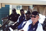 Four golfers in cart