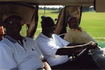 Three men relaxing on golf cart