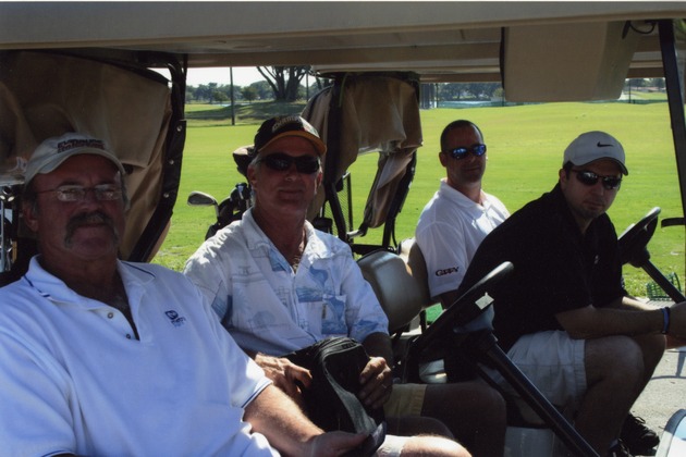 Four men in two golf carts