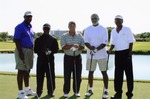 Five men posing on golf course