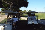 Golfers sitting in golf carts