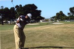 Man prepares to swing golf club