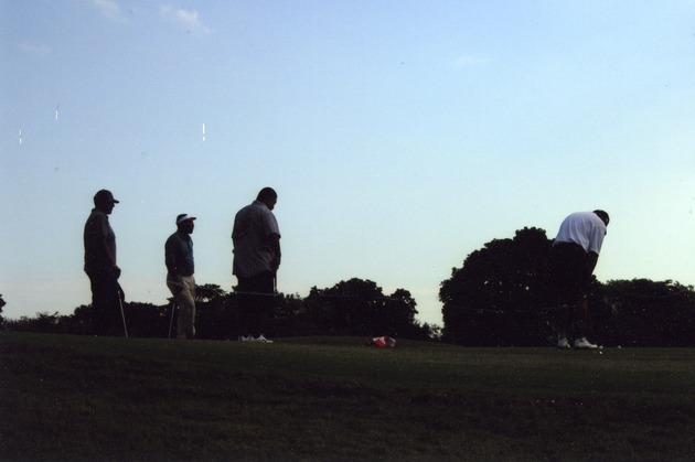 Golfers at sunset