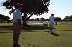 Two men playing golf