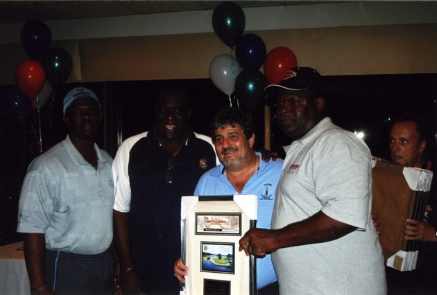 Larry Little standing with guests