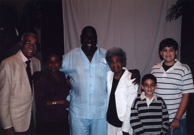 Larry Little poses with guests and children