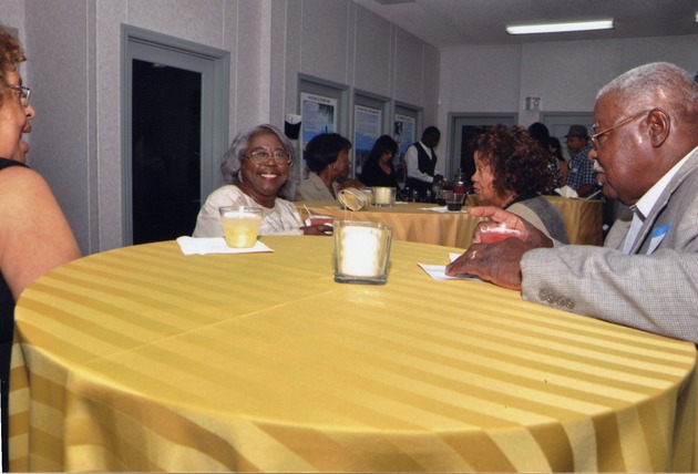 Several guests sit at tables