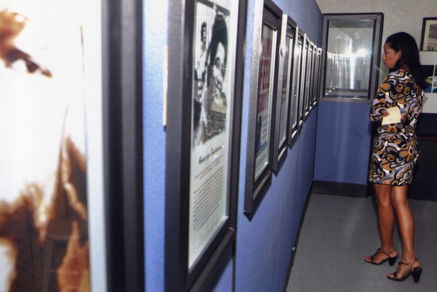 Woman looking at framed pictures