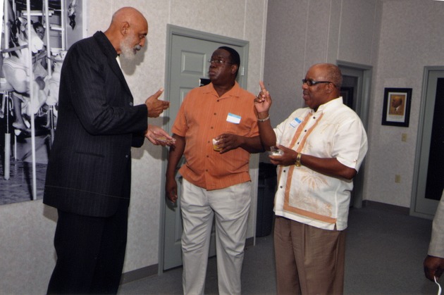 Gene Tinnie and two men talking