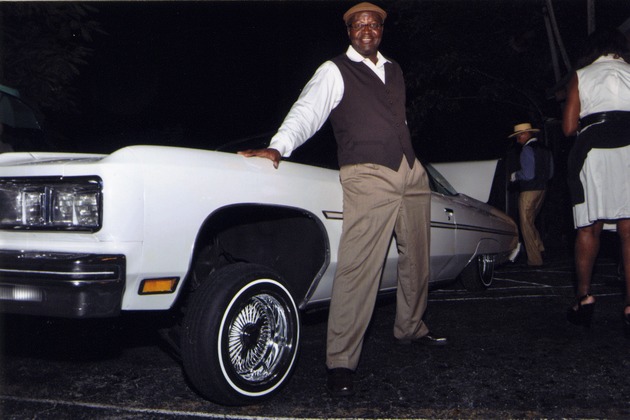 Guy Forchion stands next to vintage car